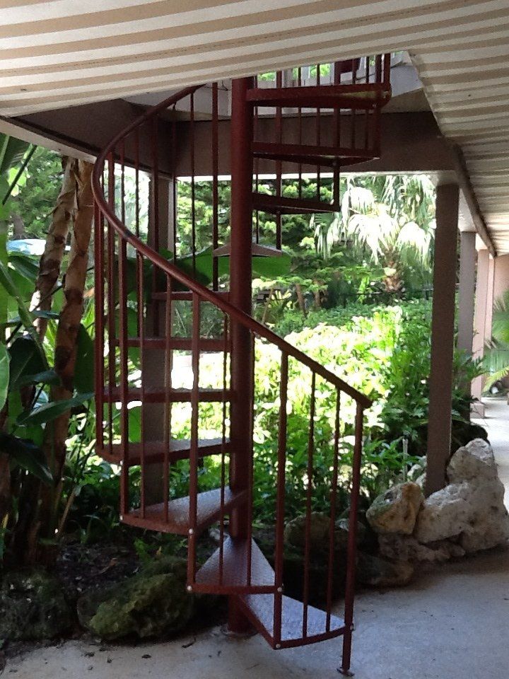 A spiral staircase leading up to a covered walkway