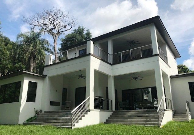 A large white house with stairs leading up to it