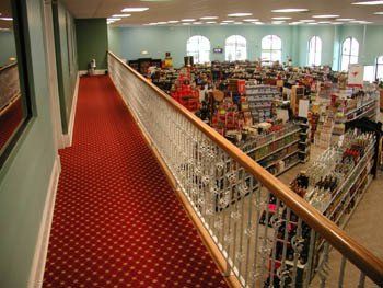 A view of a store from a balcony with a red carpet