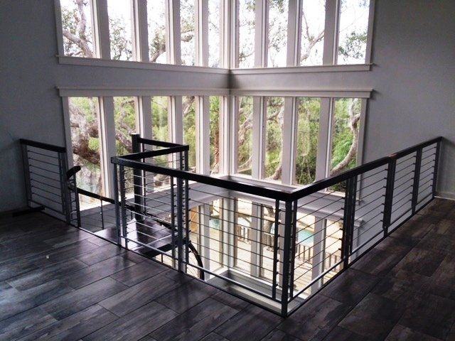 A staircase with a railing and lots of windows