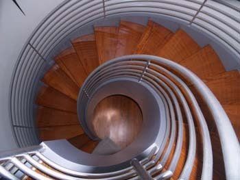 A spiral staircase with wooden steps and a metal railing