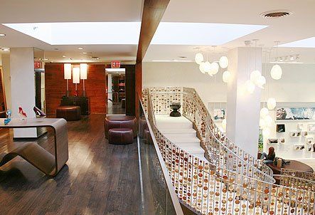 A large room with a staircase leading up to the second floor