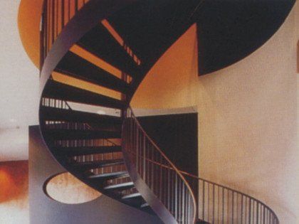 A black spiral staircase with a metal railing