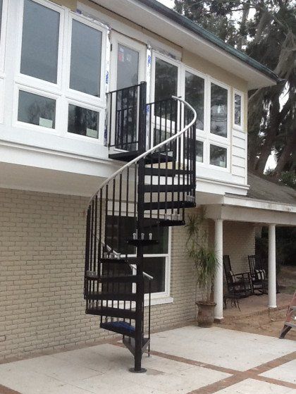 A house with a spiral staircase leading up to the second floor