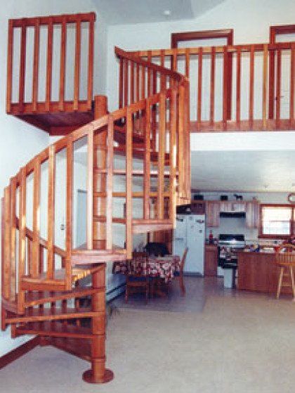 A wooden spiral staircase leading to the second floor of a house