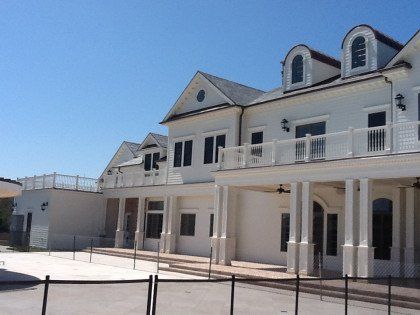 A large white house with a balcony on top of it
