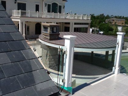 A large house with a roof that is covered in shingles