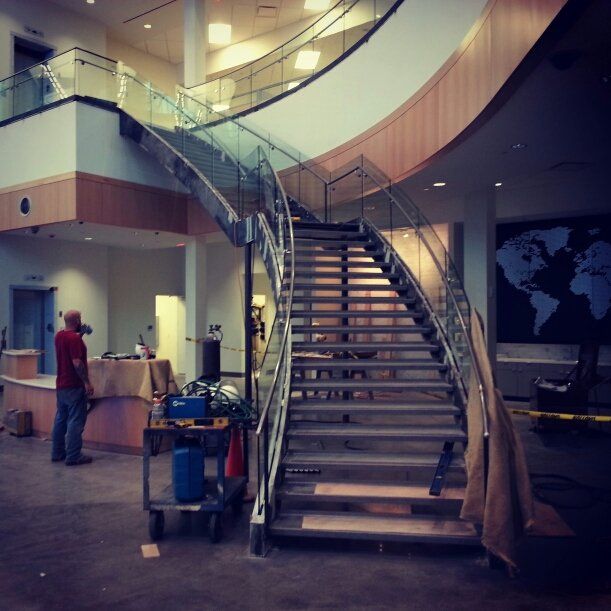 A staircase in a building with a map of the world on the wall