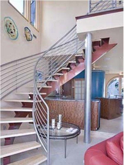 A living room with a staircase leading up to the second floor