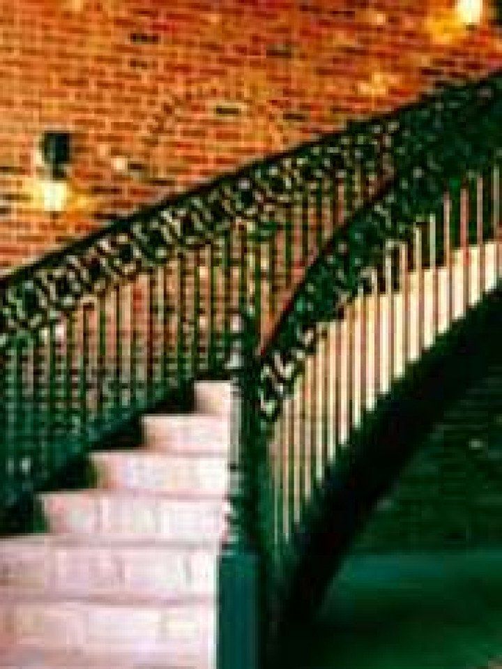 white curved staircase with black railing
