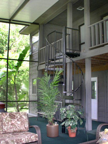 A living room with a spiral staircase and a couch