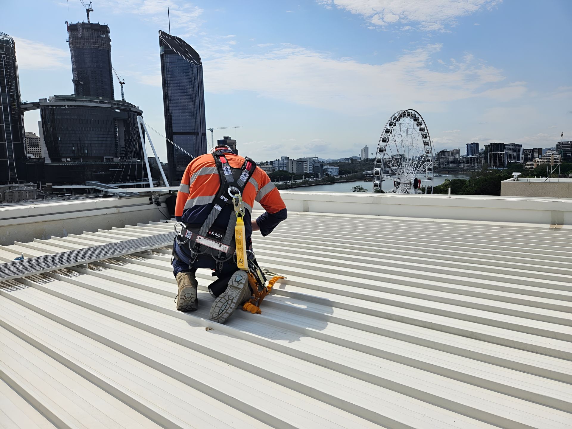 Person in Safety Gear Working on a White Metal Roof — Australian Asset Compliance in Emerald, QLD