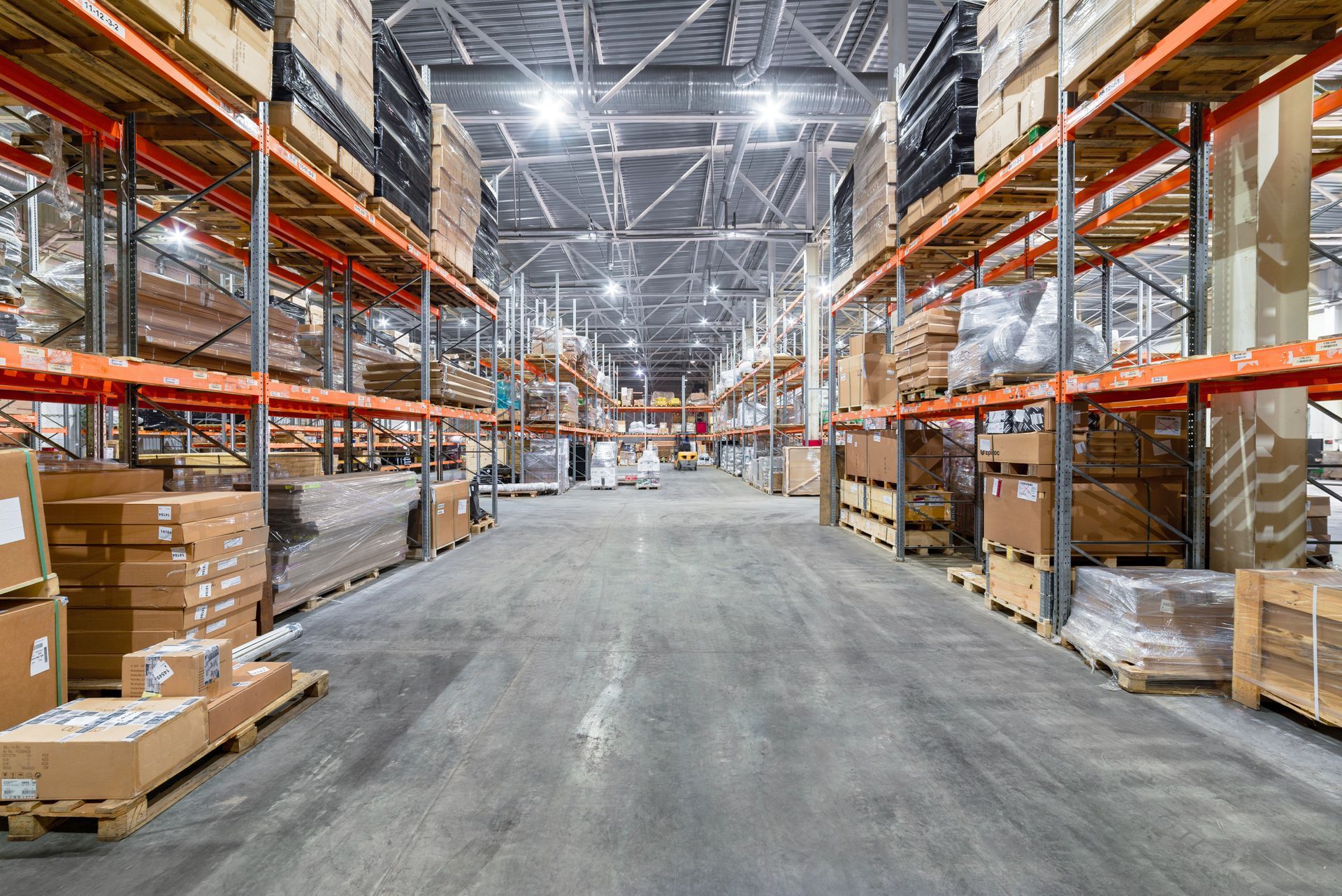 Warehouse Interior With Rows of Shelves Filled With Boxes and Pallets — Australian Asset Compliance in Hunter Valley, QLD