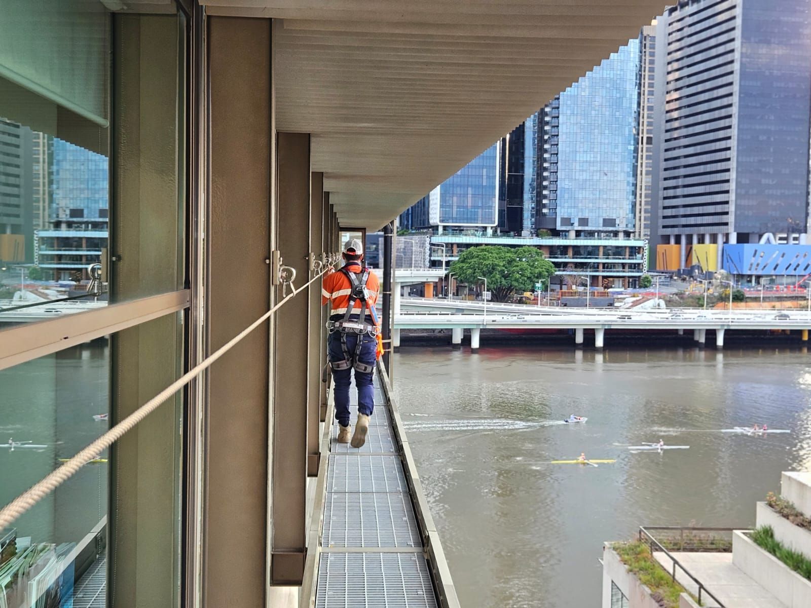 A Worker in Safety Gear Walks on a Narrow Platform — Australian Asset Compliance in Emerald, QLD