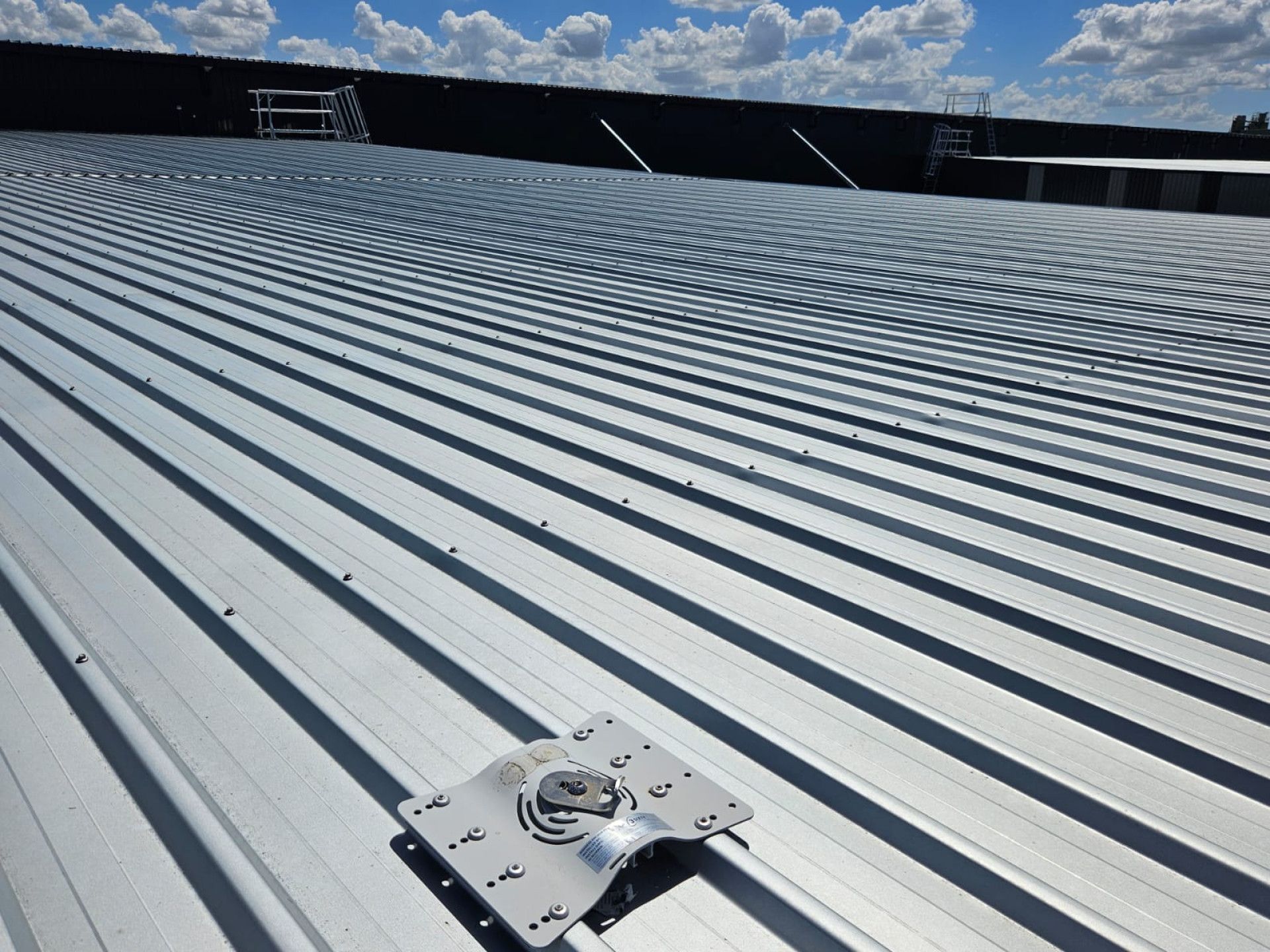 Metal roof with a mounted, silver component. — Australian Asset Compliance in Glanmire, QLD