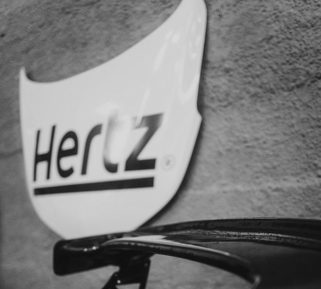 A black and white photo of a hertz sign