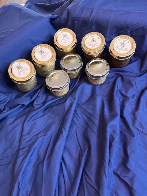 A bunch of plastic cups filled with sauce on a counter