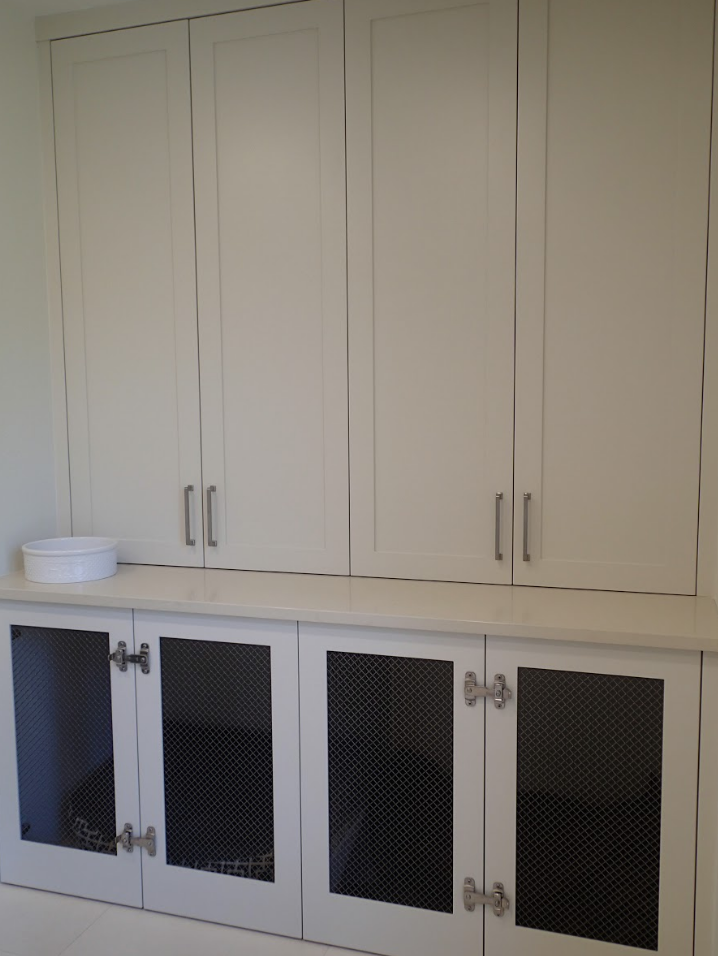 White cabinets, upper and lower, with metal mesh inserts in lower doors.