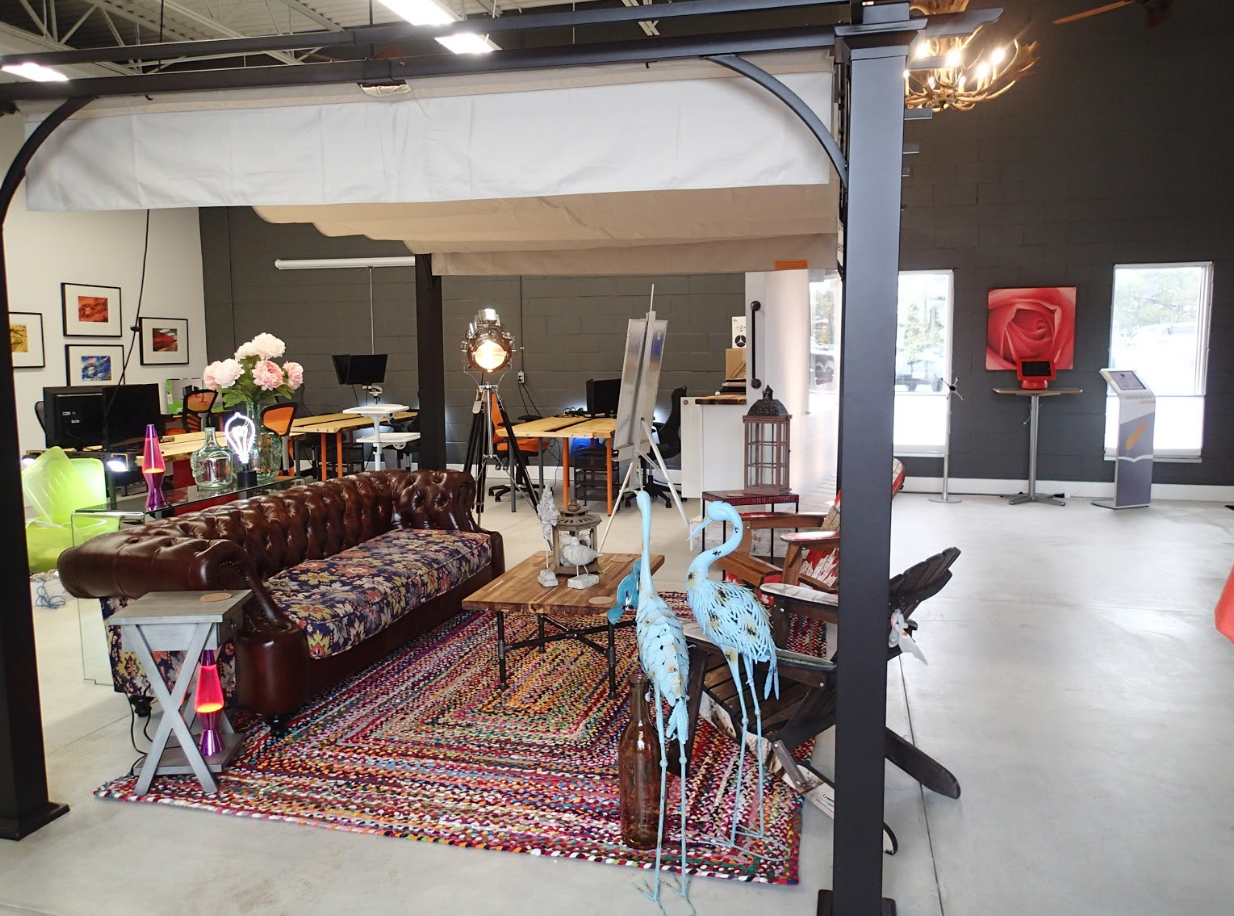 Indoor scene with eclectic furniture and decor; dark walls and large windows.