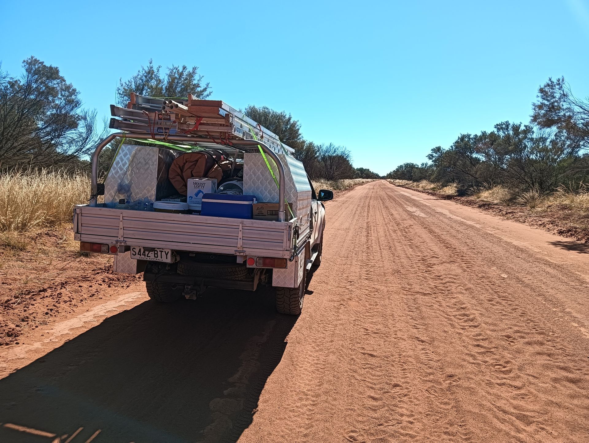 A truck is parked on the side of a dirt road — Ross Painting In Ciccone, NT