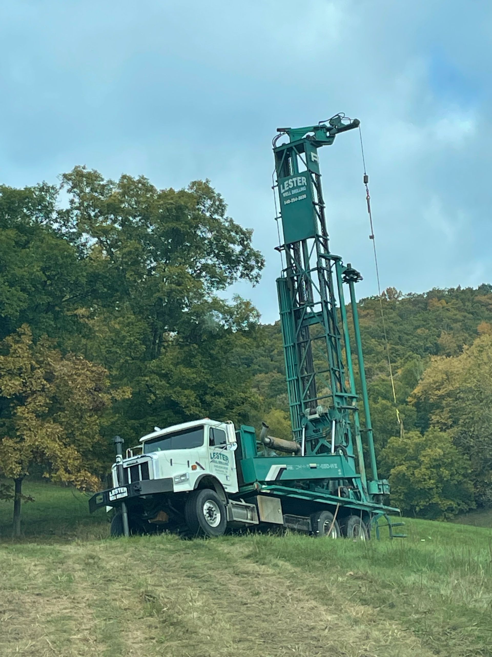 Large Green And White Truck Parked in a Grassy Field | Buchanan, VA | Lester Well Drilling Inc