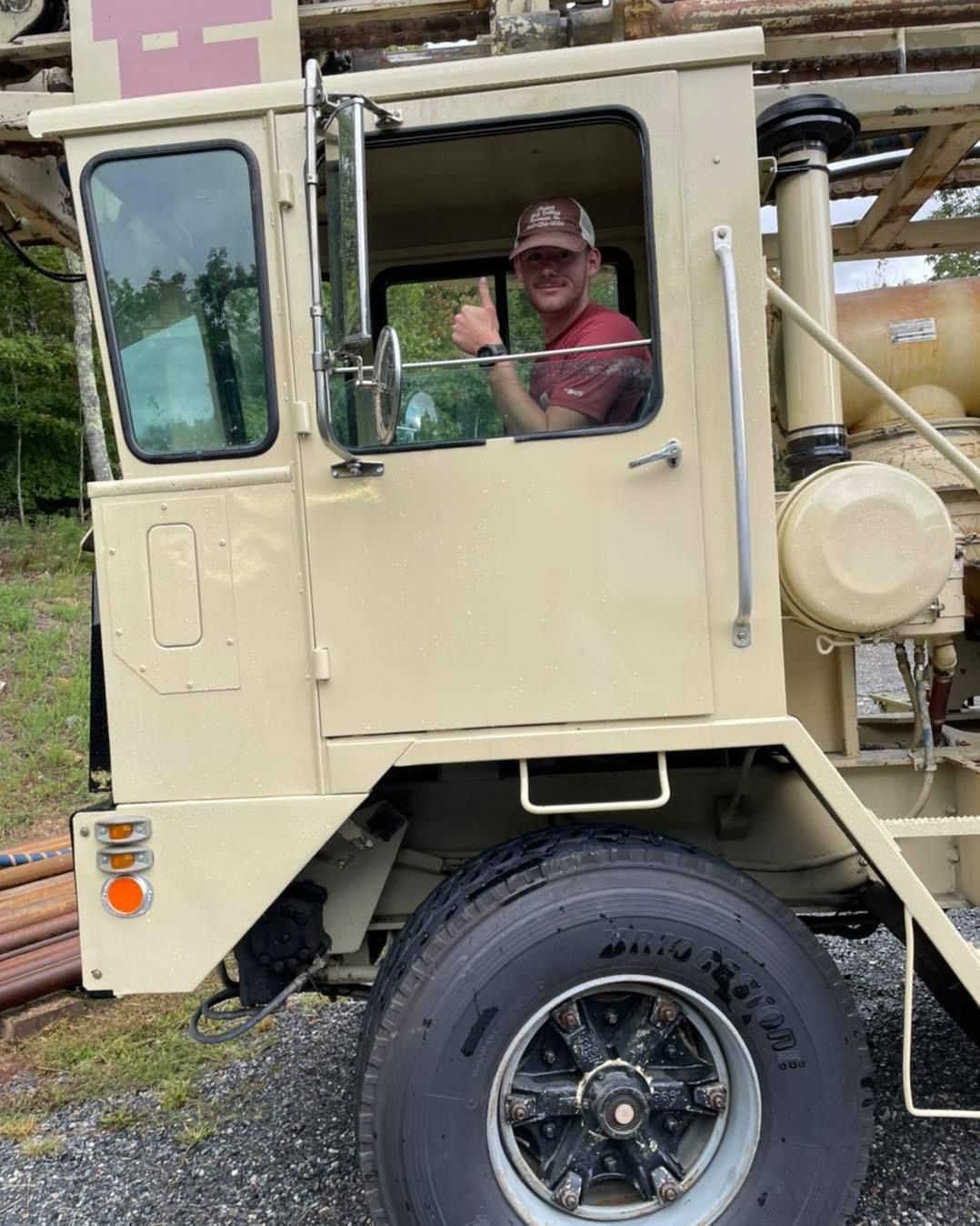 A Man Sitting in the Driver's Seat of a Truck Giving a Thumbs Up | Buchanan, VA | Lester Well Drilling Inc
