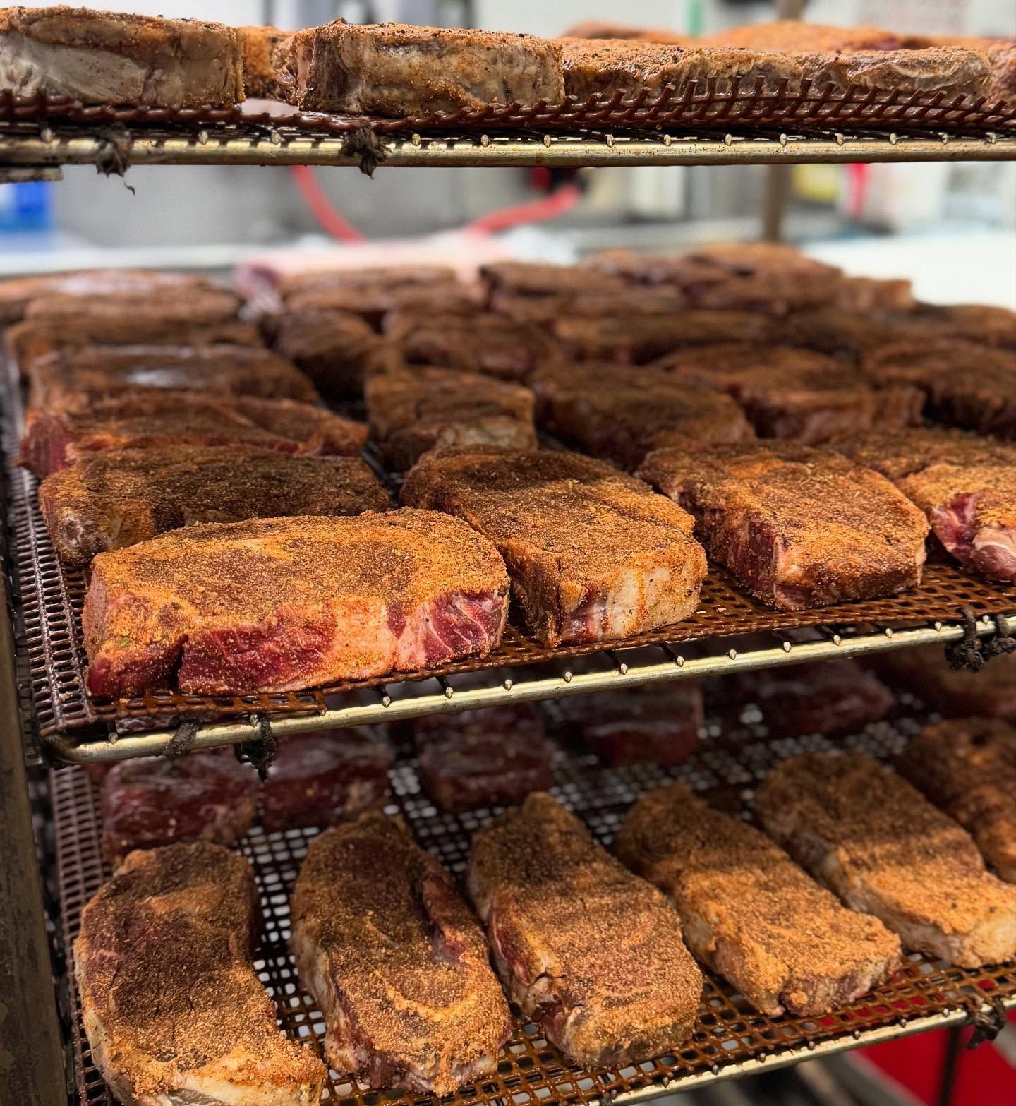 A bunch of meat is sitting on a wire rack.