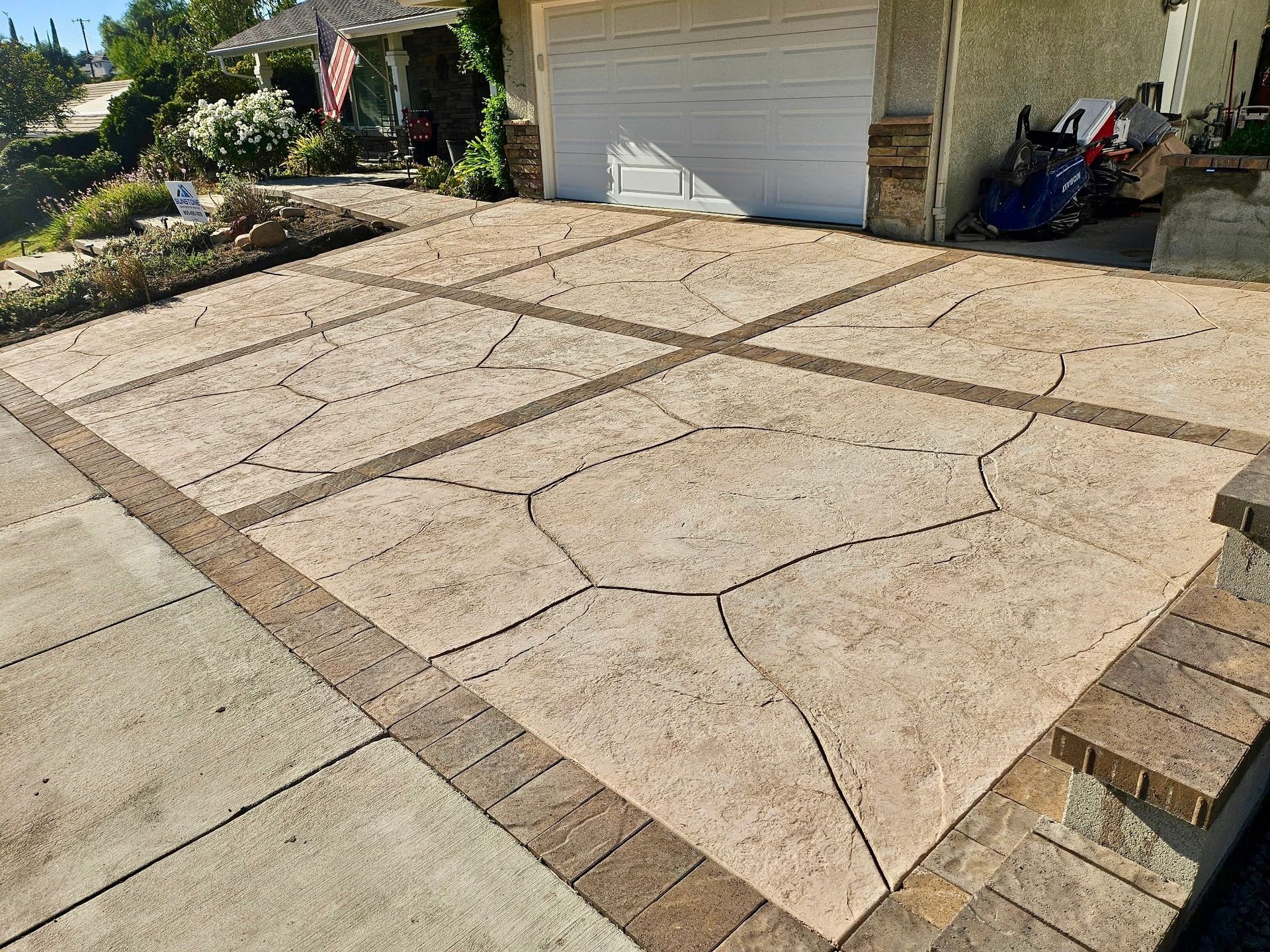 A red car is parked in front of a modern house.