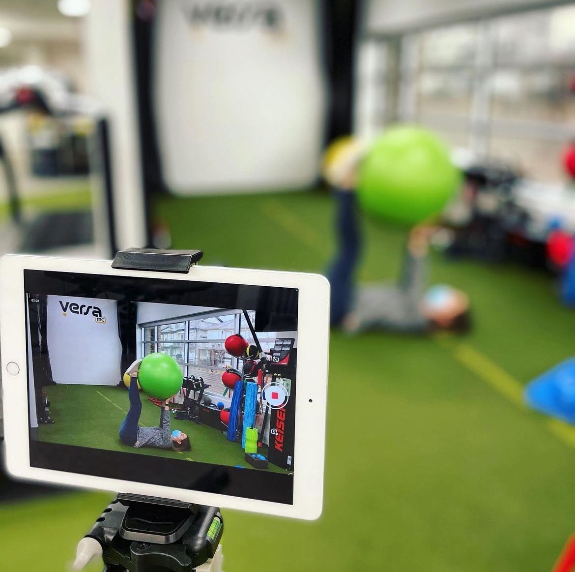 A tablet is being used to record a video of a gym