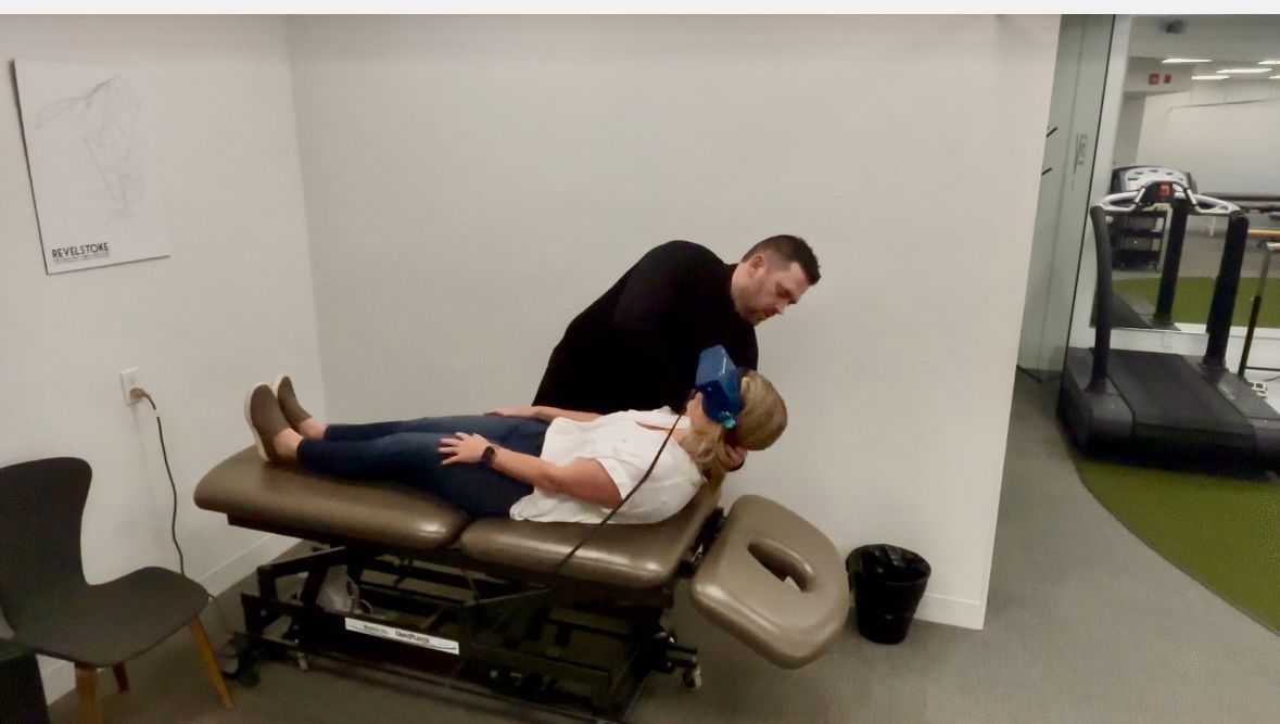 A man is giving a woman a massage on a table.