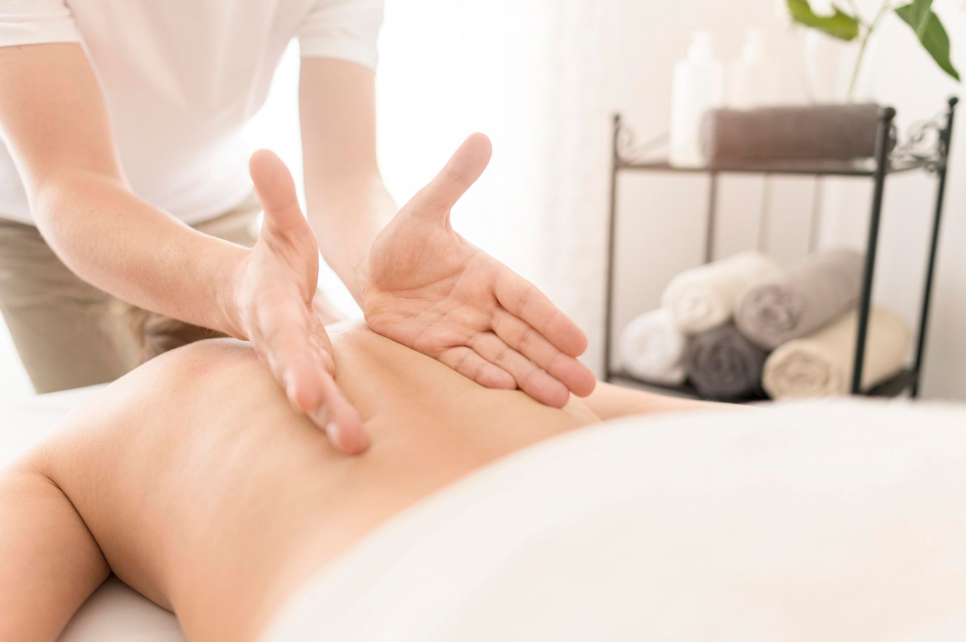 A man is giving a woman a massage in a spa.