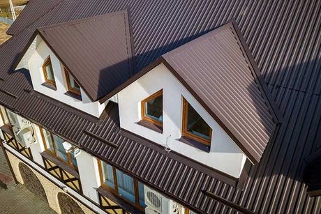 Building attic rooms exterior on metal shingle roof