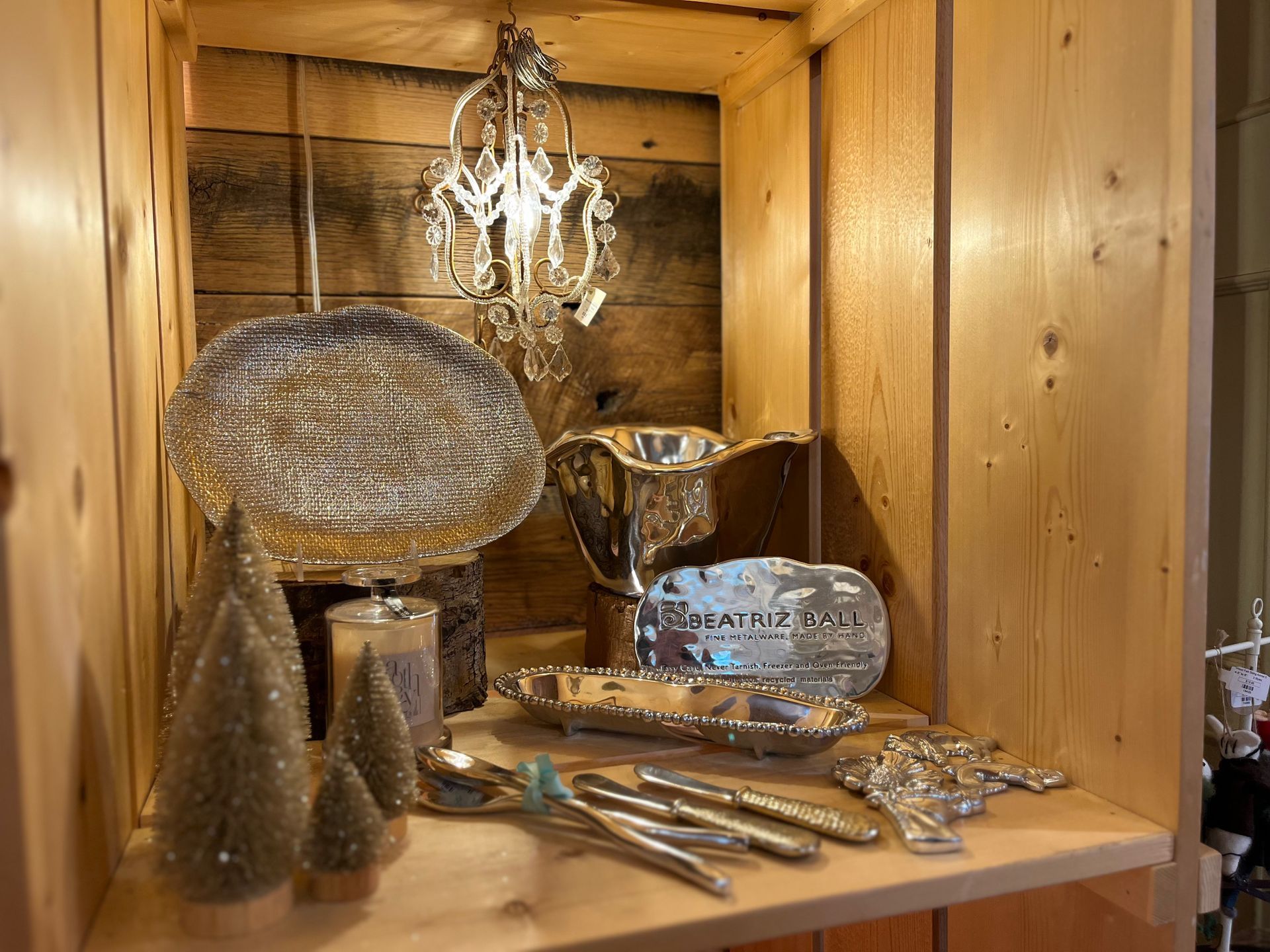A wooden shelf with a variety of christmas decorations on it.