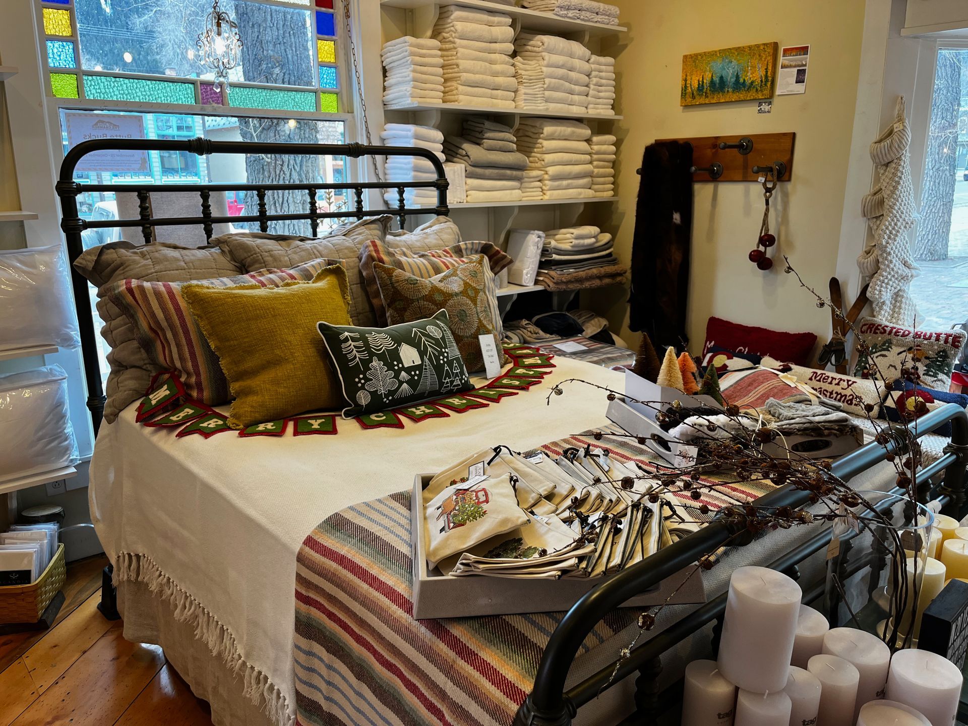 A bed with a blanket and pillows on it in a room.