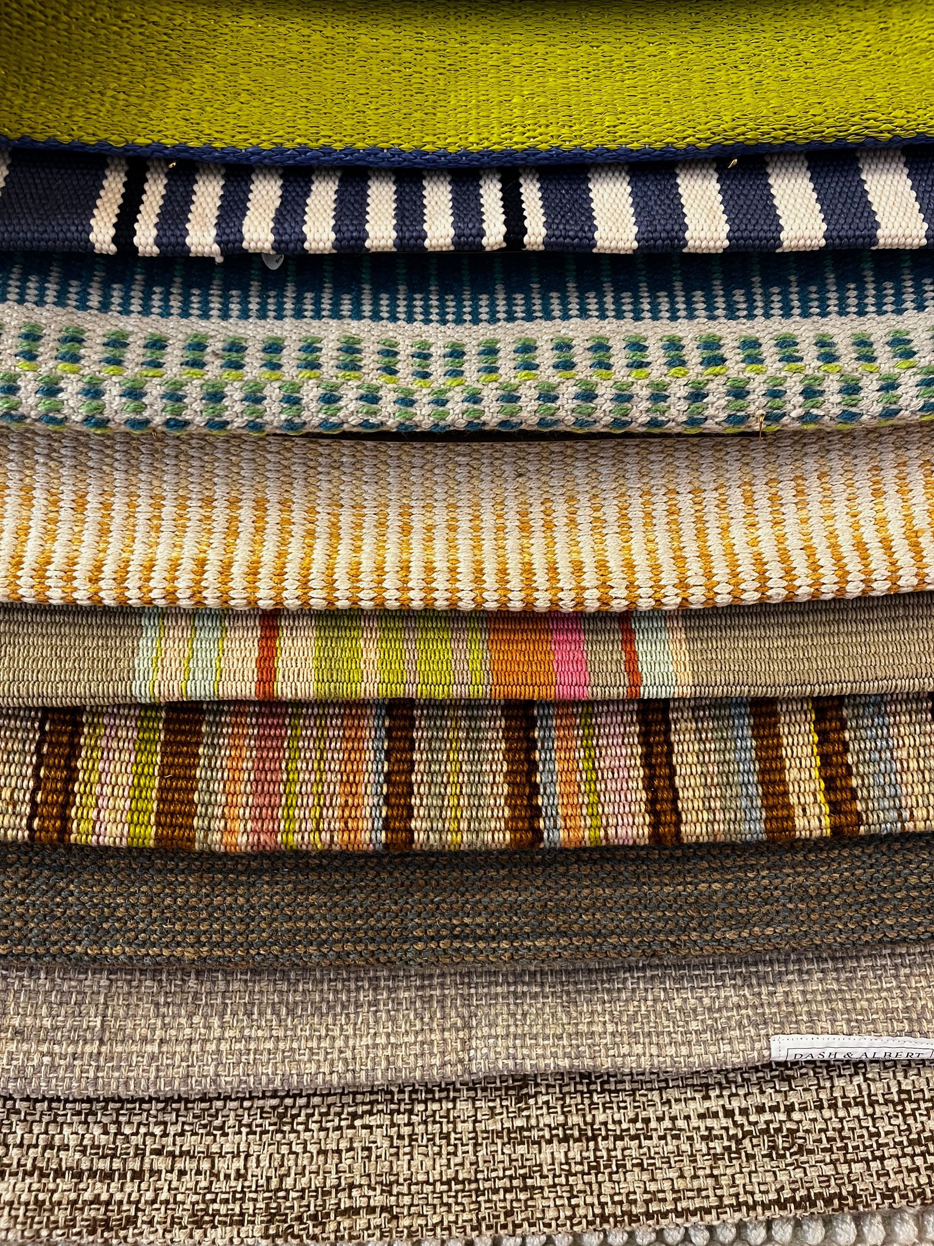 A close up of a stack of colorful fabrics.