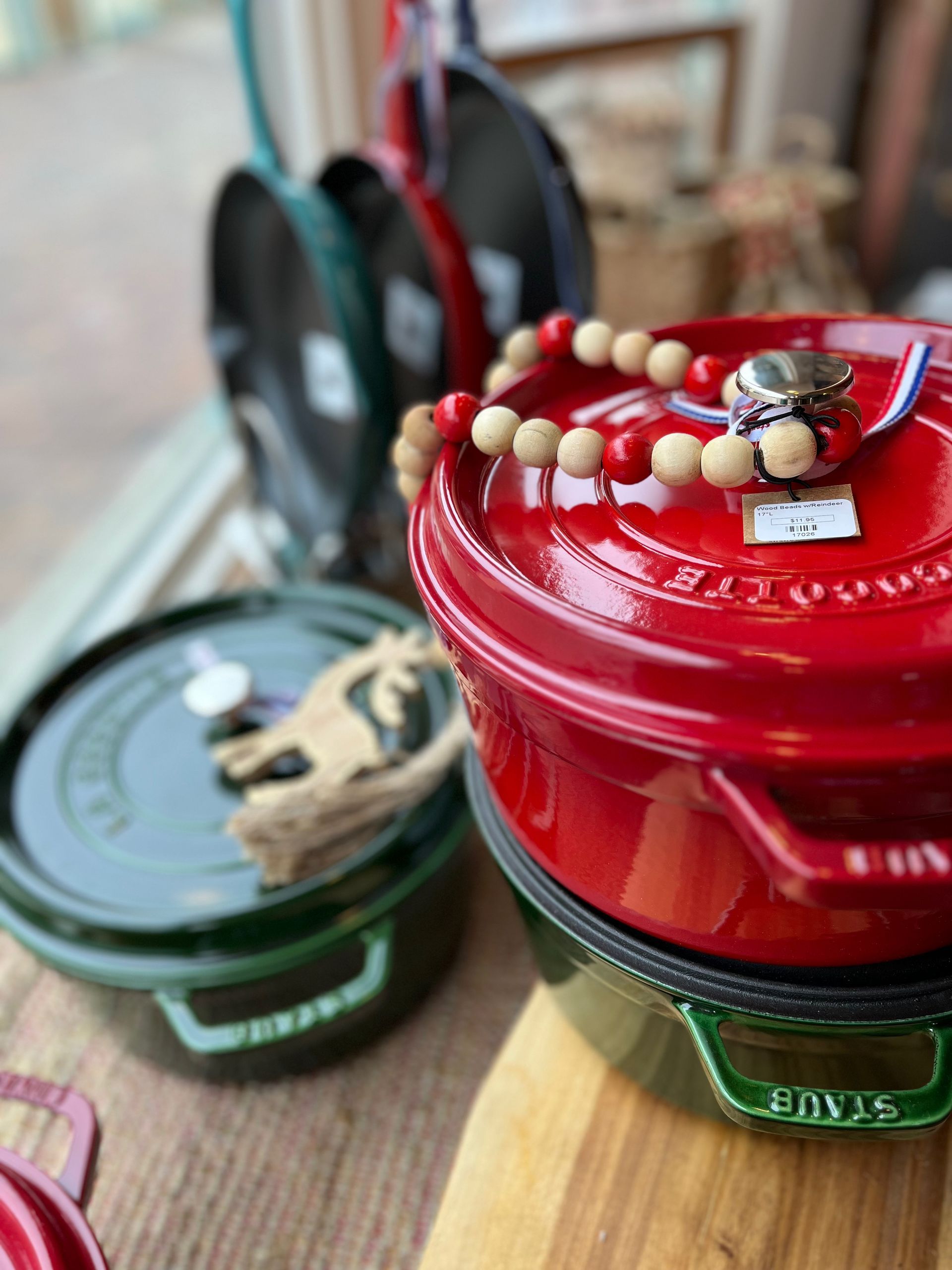 A red pot with a bracelet on top of it