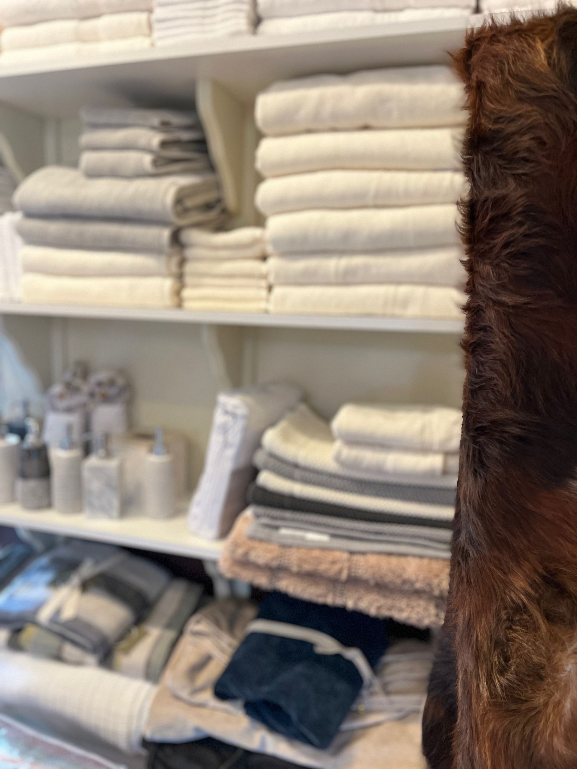 A pile of towels is on a shelf in a store