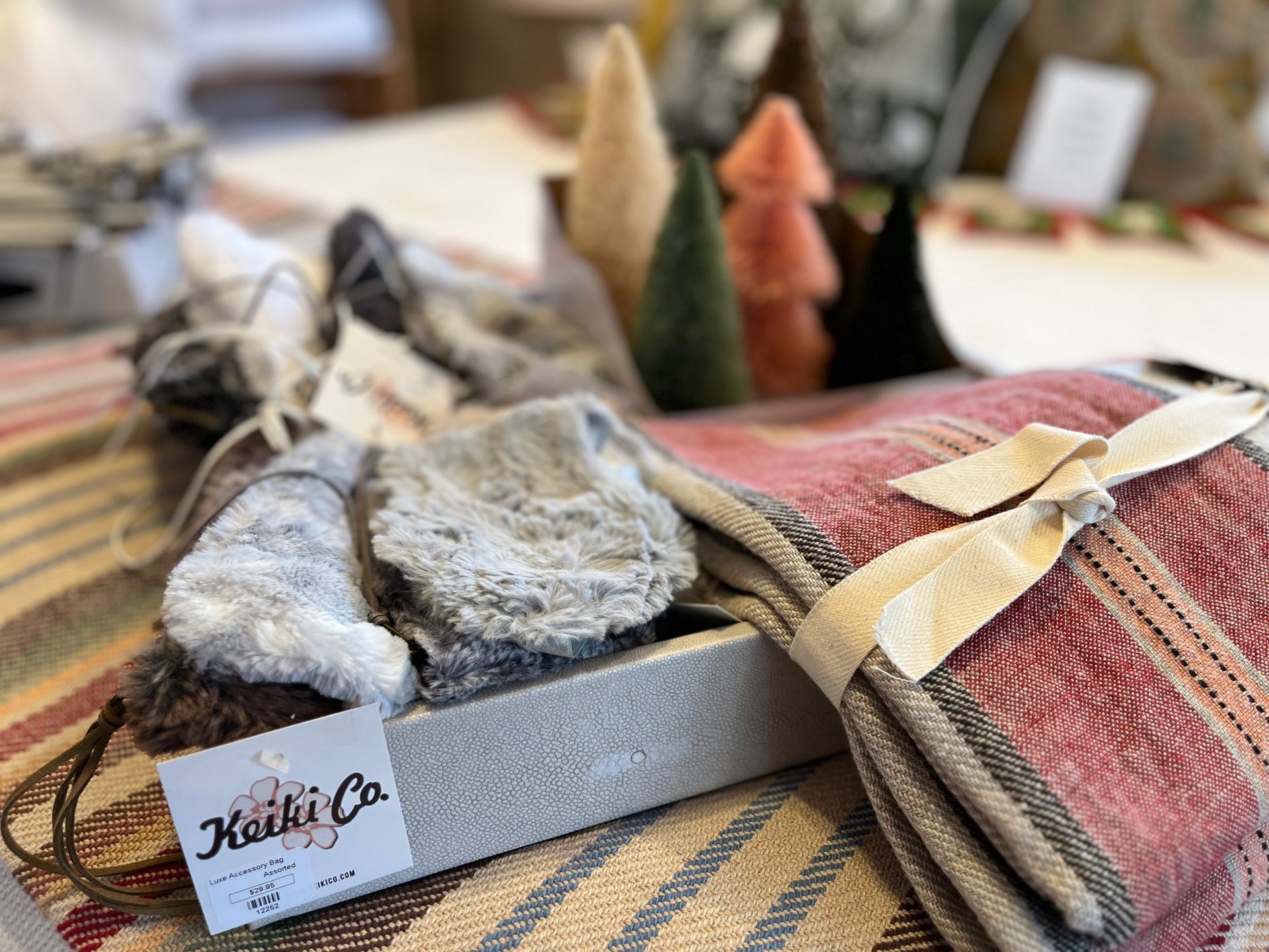 A blanket is sitting on top of a table next to a box.