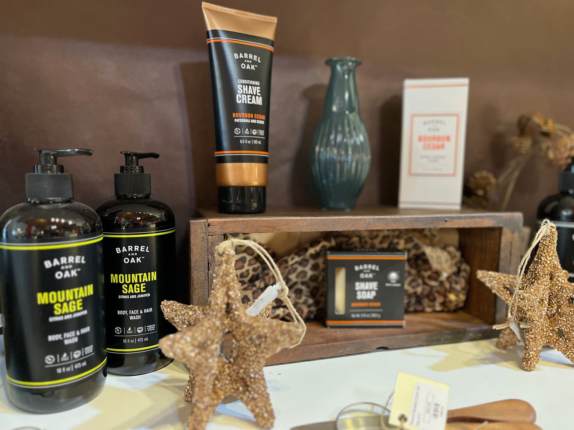 A table topped with bottles of shampoo , lotion , and soap.