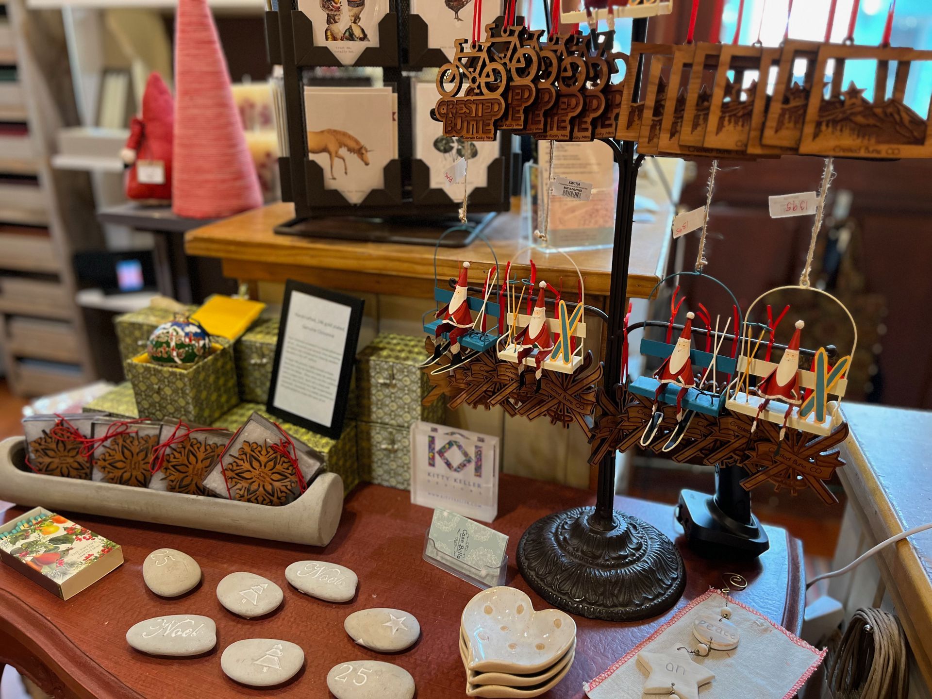 A table with a variety of items on it including earrings and coasters.