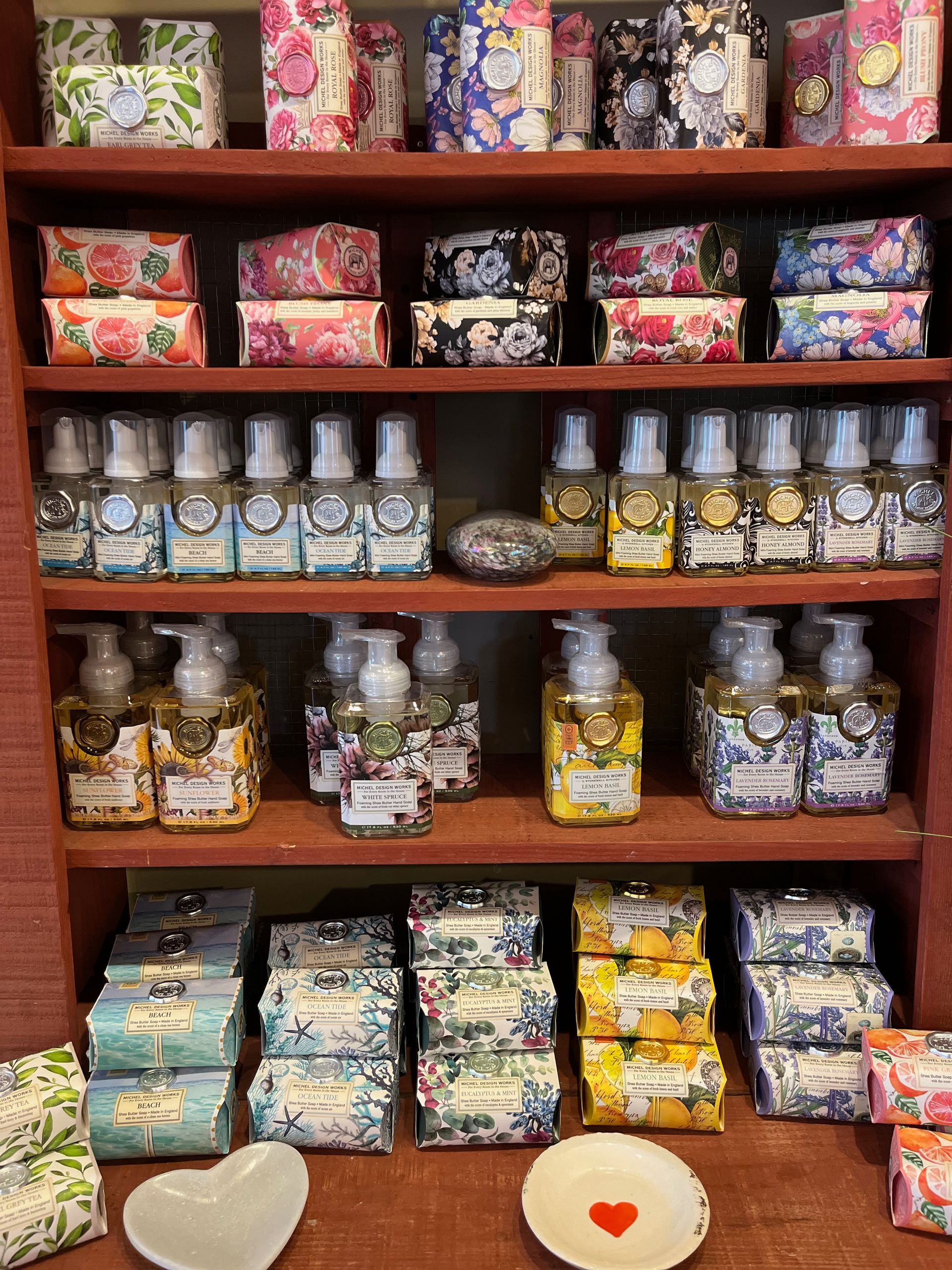 A shelf filled with lots of soaps and bottles.