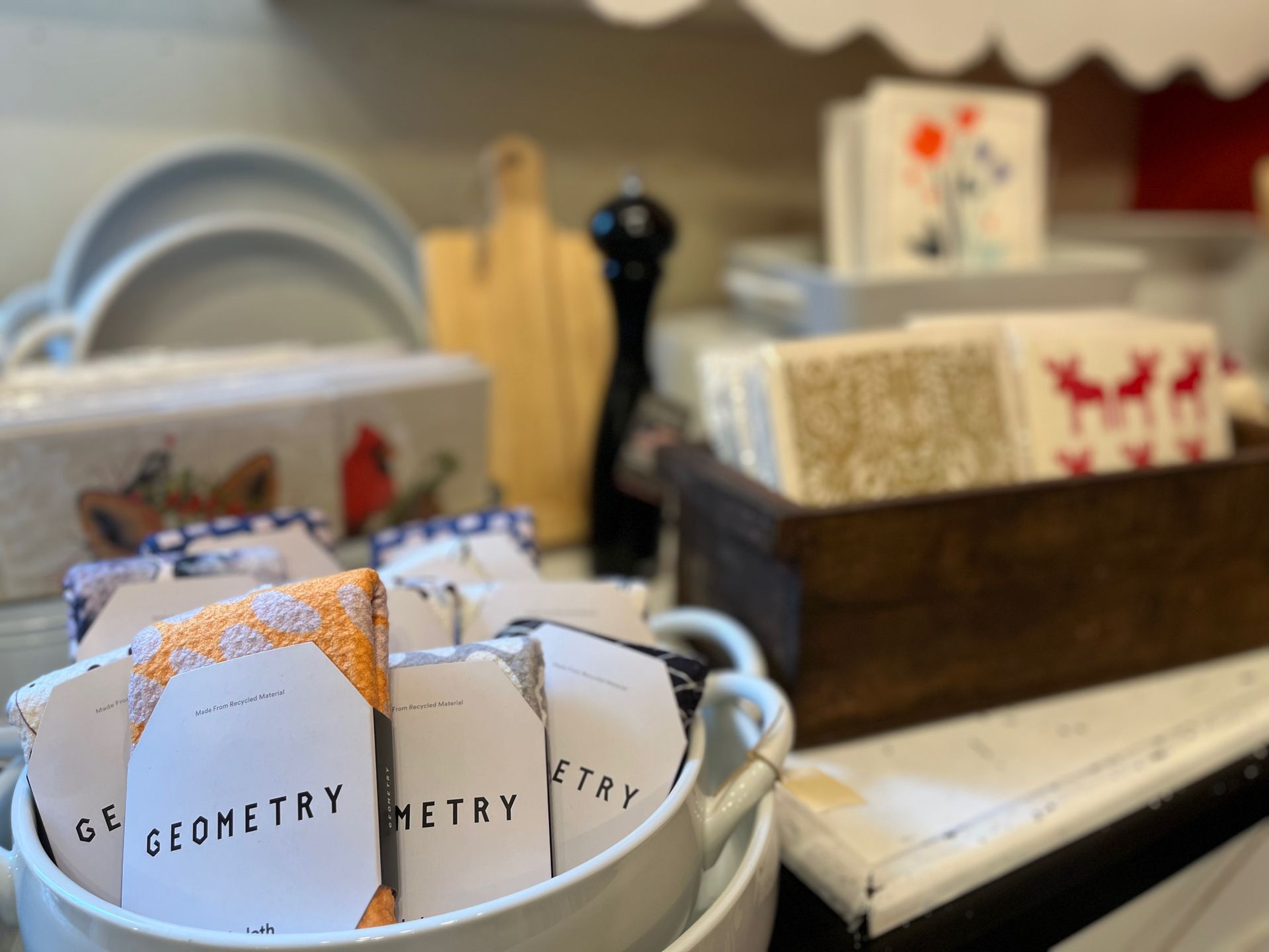 A white bucket filled with geometric cards on a table