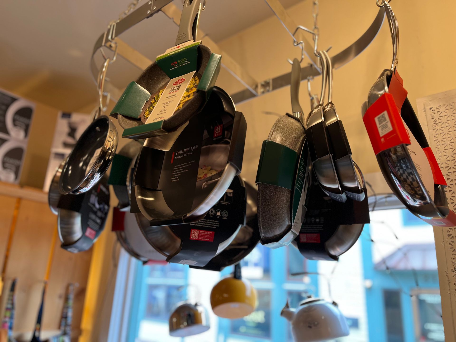 A bunch of pots and pans hanging from the ceiling