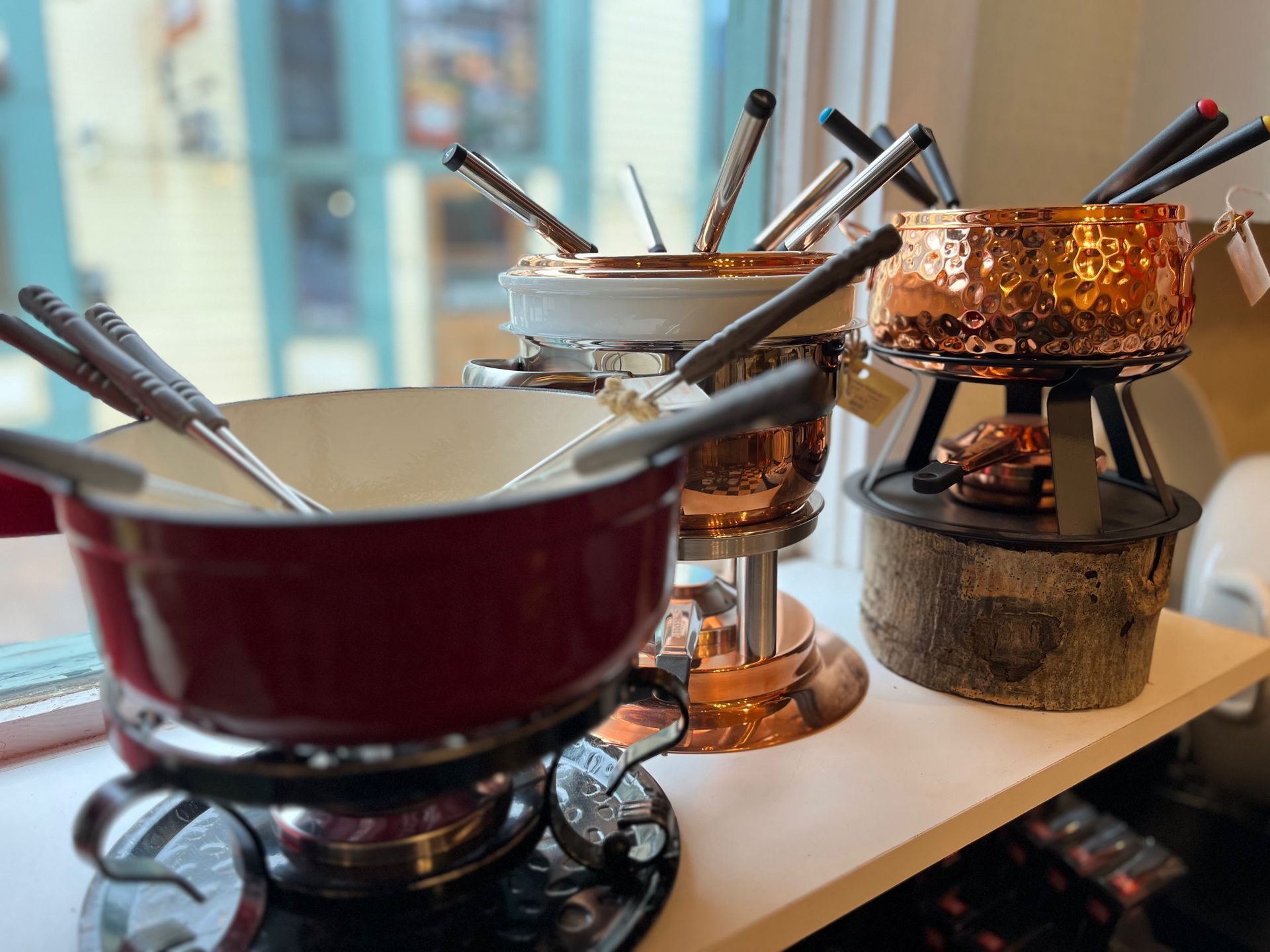 Three pots of fondue are sitting on a table.
