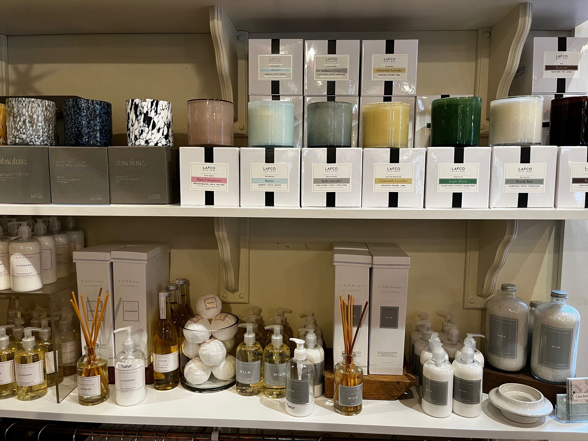 A store shelf filled with lots of candles and soaps.