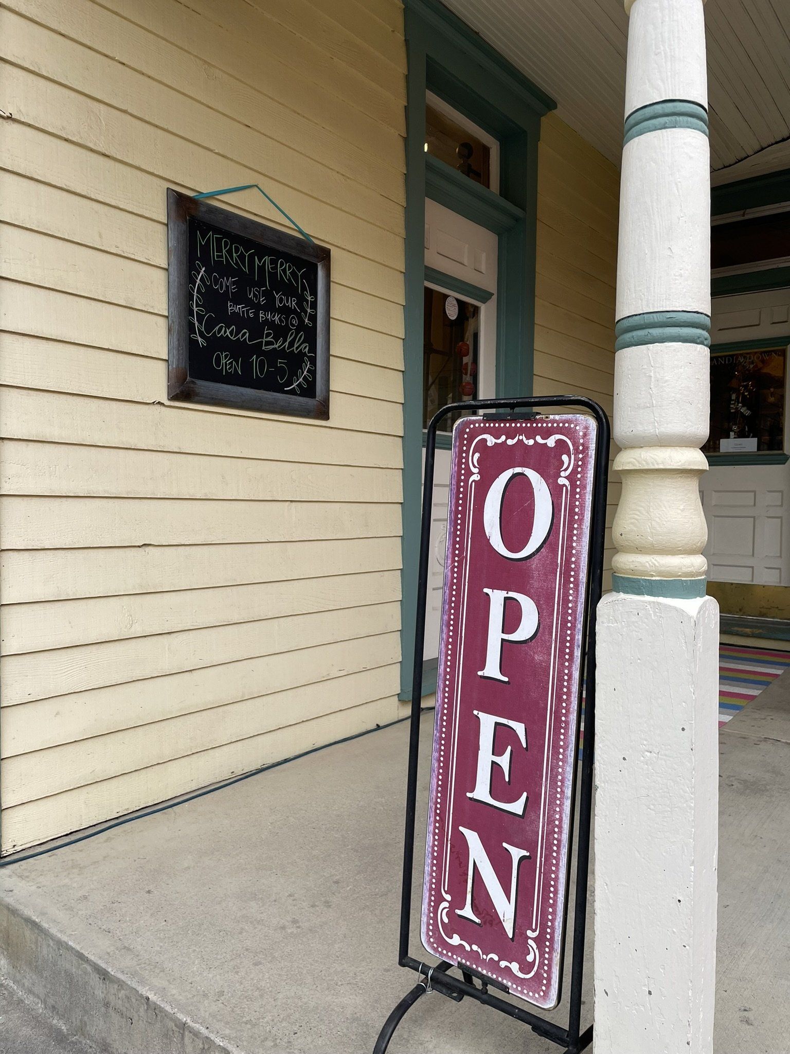 A sign that says open on it is outside of a building