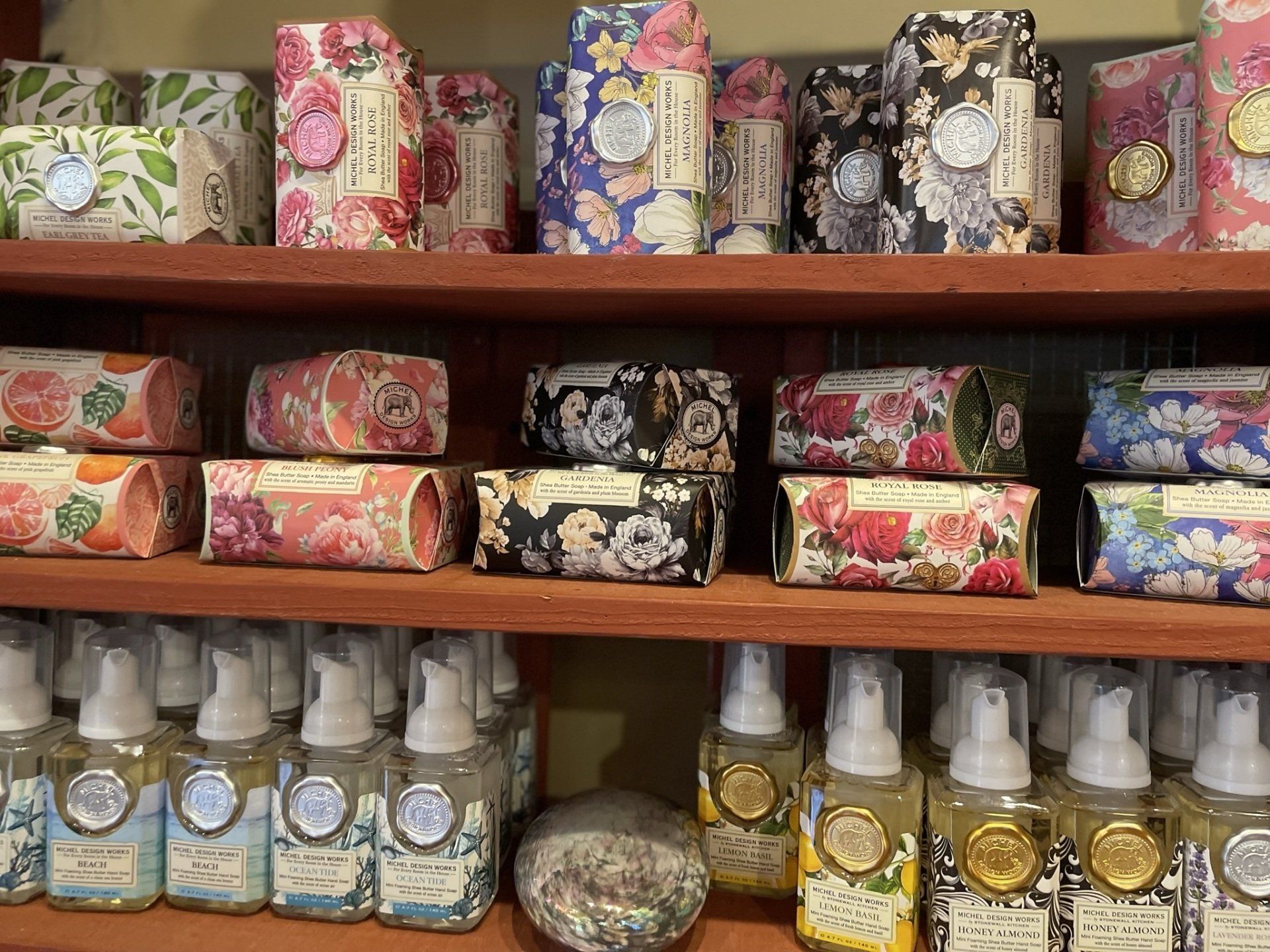 A shelf filled with lots of soaps and bottles.