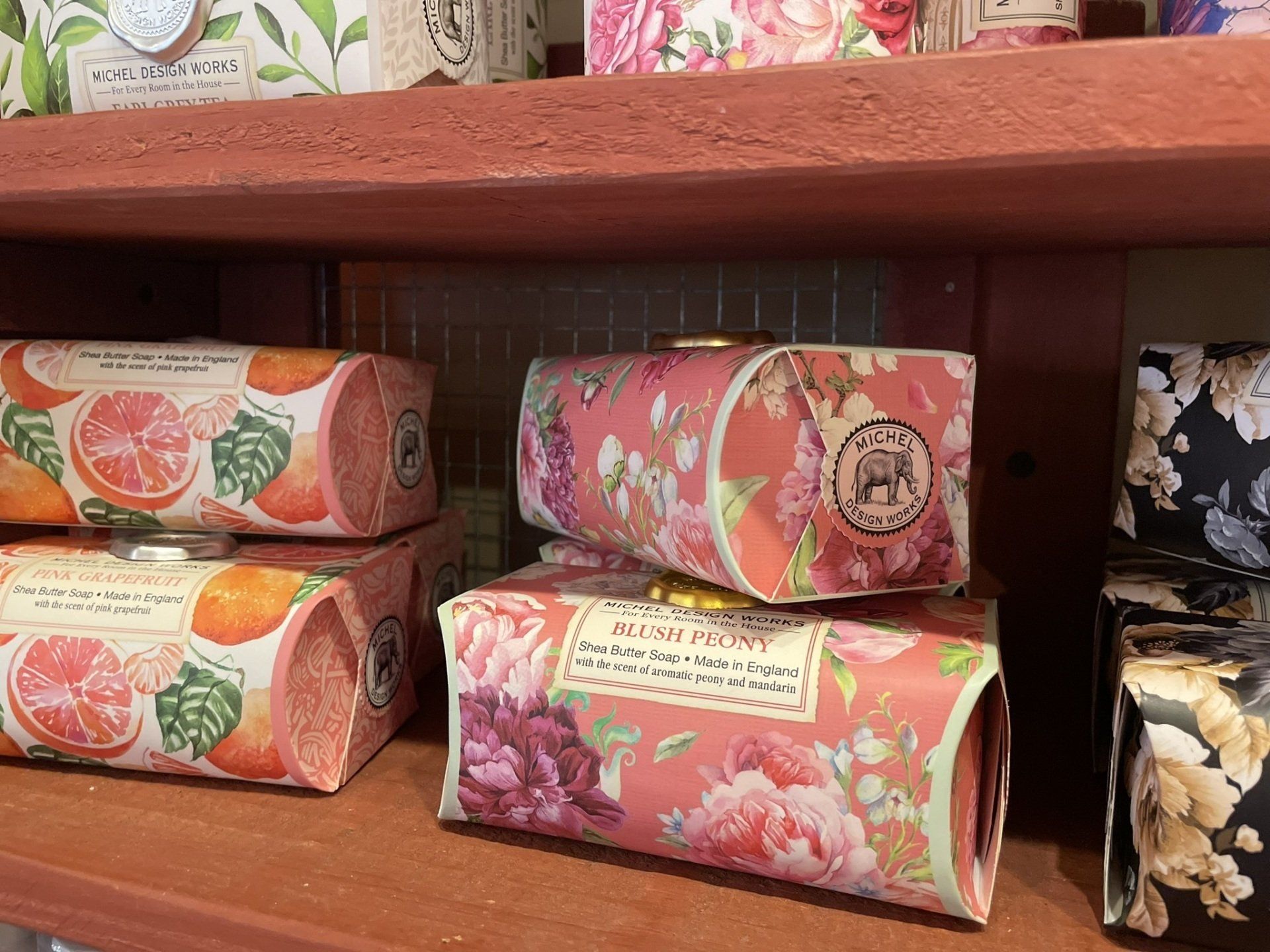 A shelf filled with lots of different types of soap.