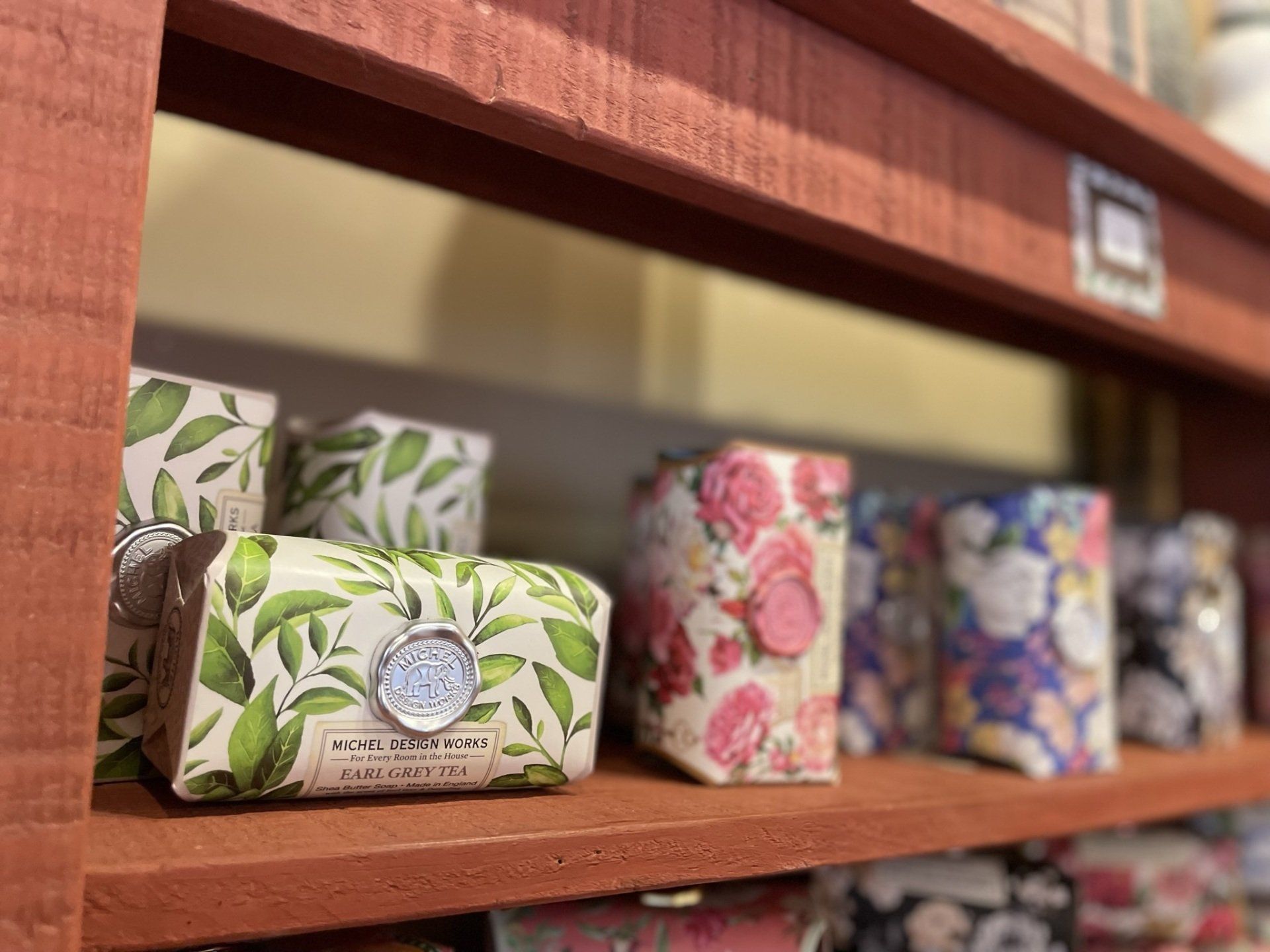 There are many different types of soaps on the shelves.