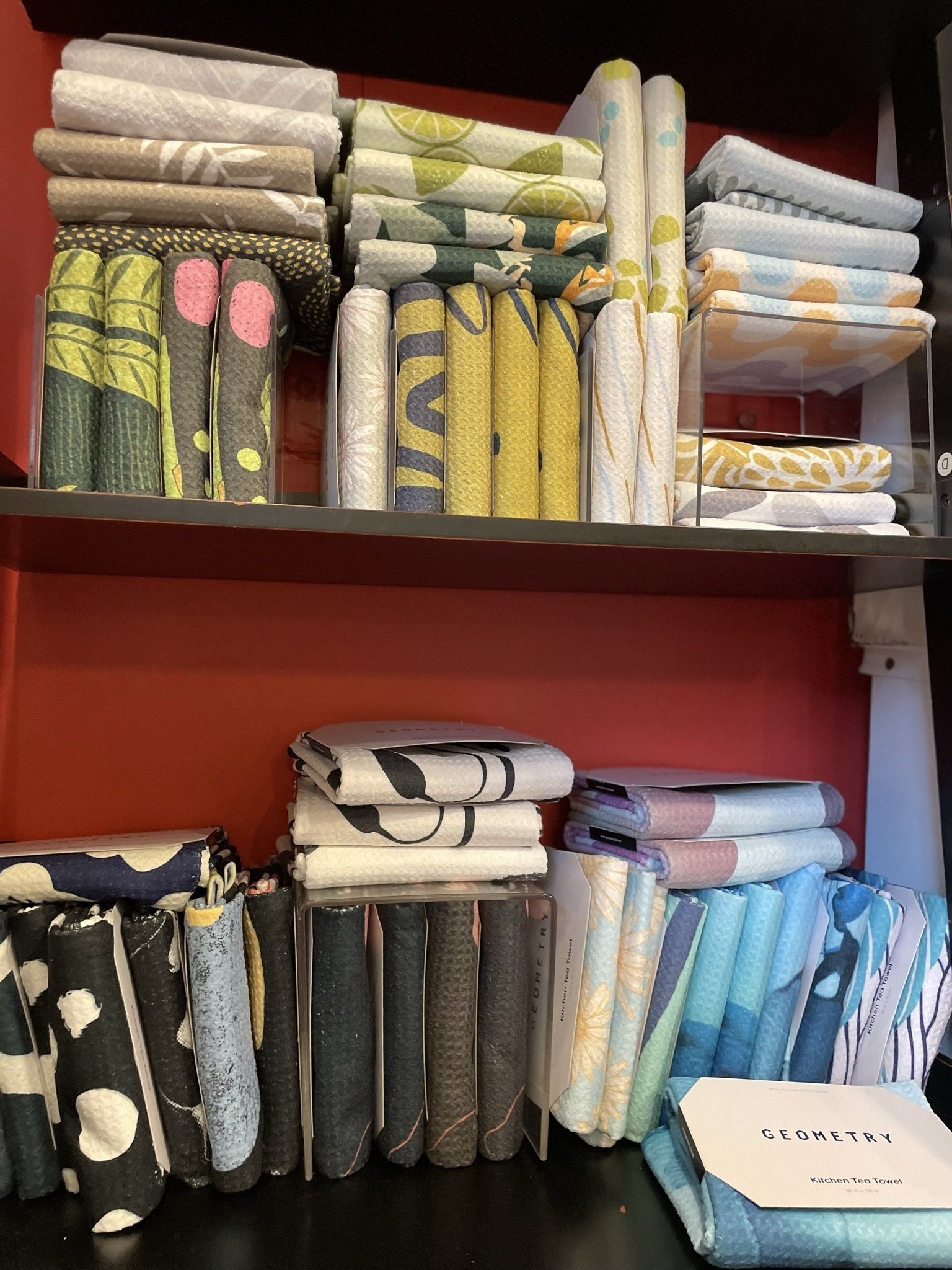A shelf filled with a variety of towels and sheets.